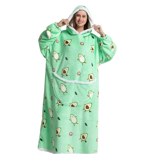 Smiling woman wearing an extra long blanket hoodie with avocado pattern.