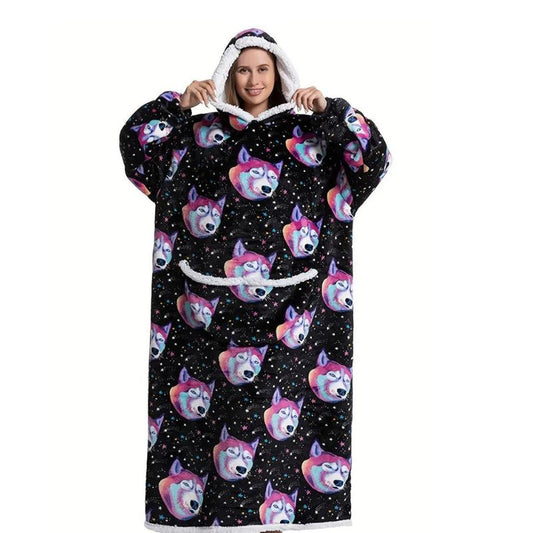 Smiling woman wearing an extra long blanket hoodie with funny dog pattern.