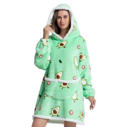 Woman wearing oversized blanket hoodie with avocado pattern.