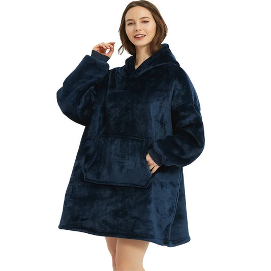 Person cozy in dark blue oversized blanket hoodie.