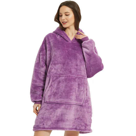 Person cozy in purple oversized blanket hoodie.