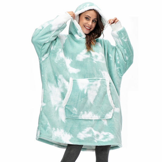 Model wearing sherpa blanket hoodie with blue tie dye pattern.