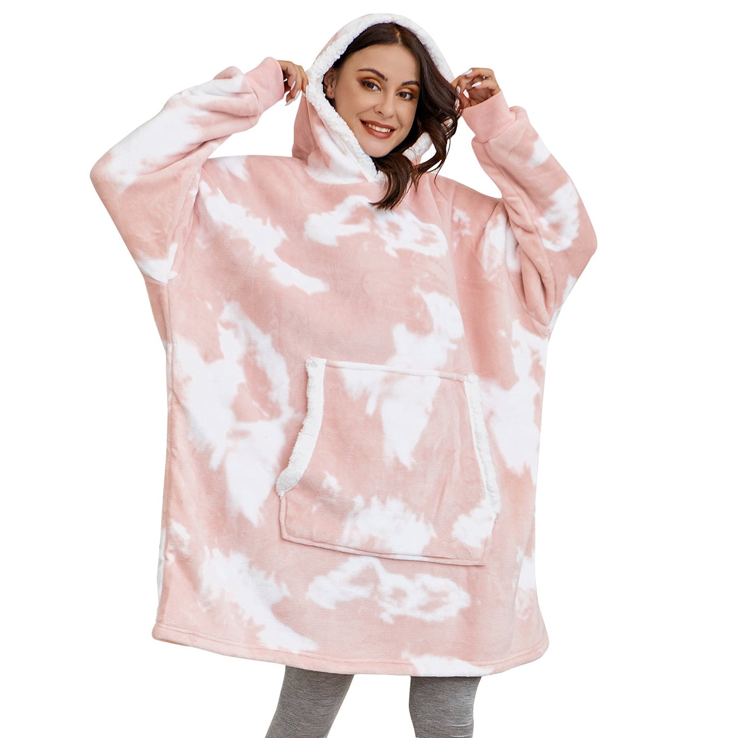 Model wearing oversized blanket hoodie with pink tie dye pattern.