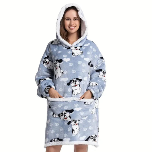 Woman in oversized blanket hoodie with dog pattern.