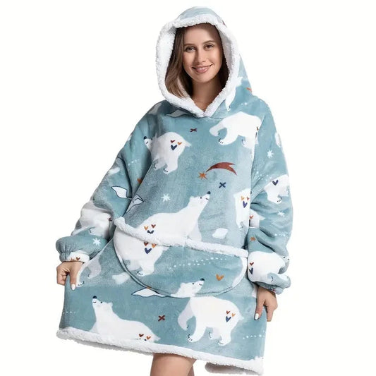 Woman in oversized blanket hoodie with polar bear pattern.