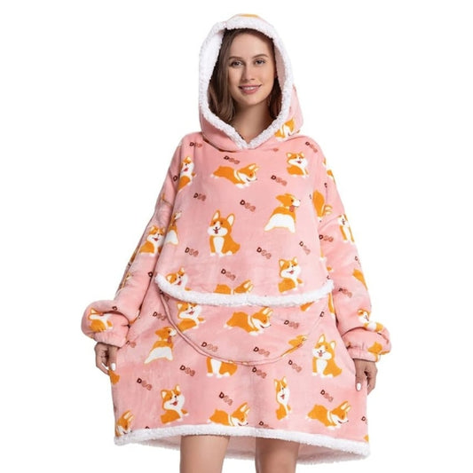 Woman in pink oversized blanket hoodie with cute dog pattern.