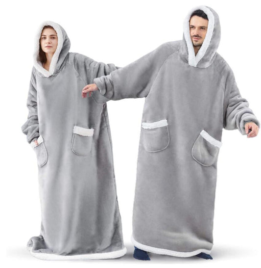 Woman and man wearing grey extra long blanket hoodies that cover from head to toe.