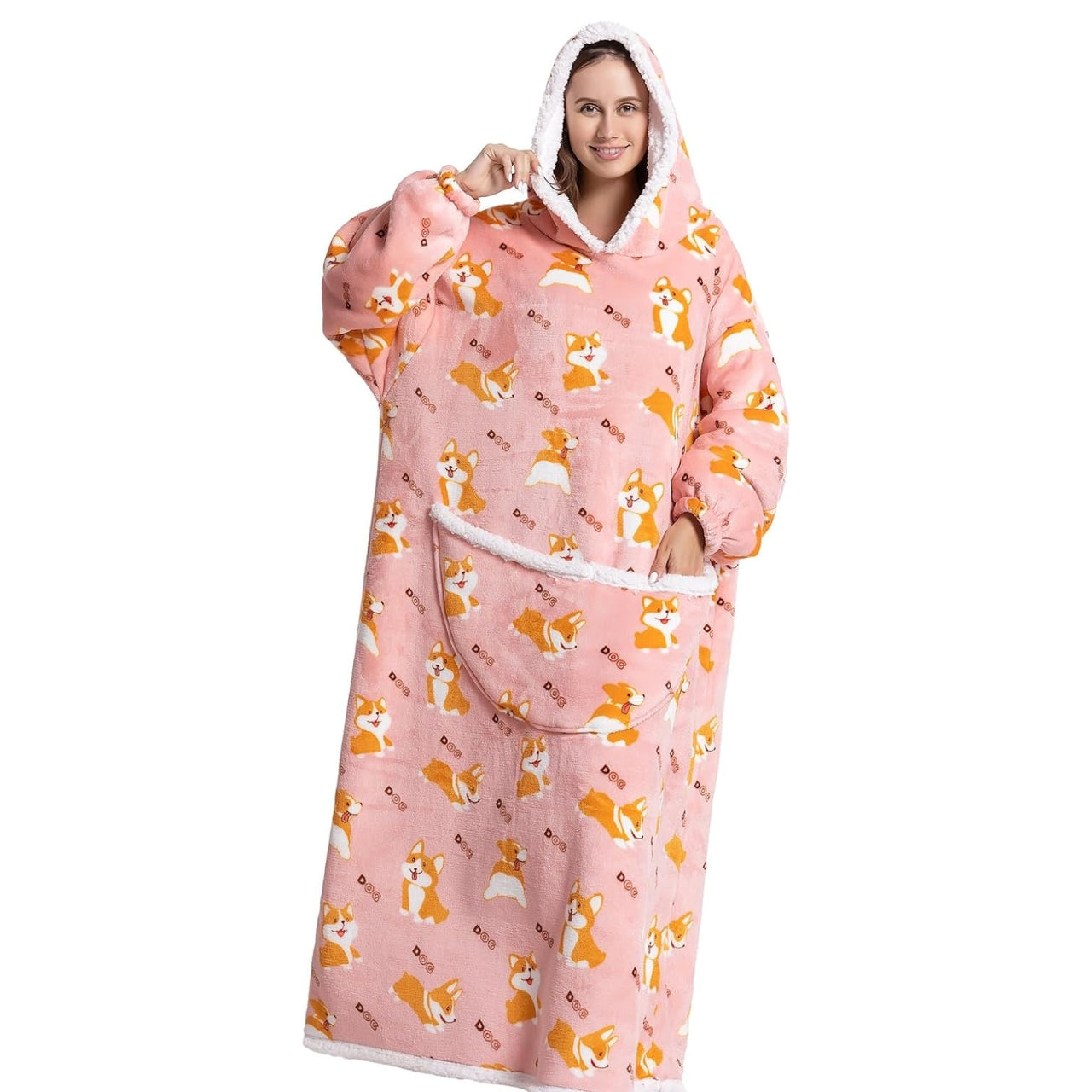 Smiling woman wearing a pink extra long blanket hoodie with dog pattern. 