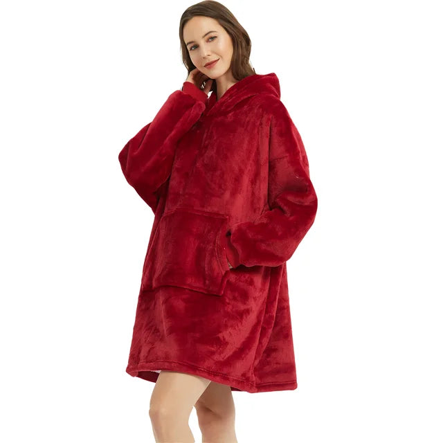 Person cozy in red oversized blanket hoodie. 