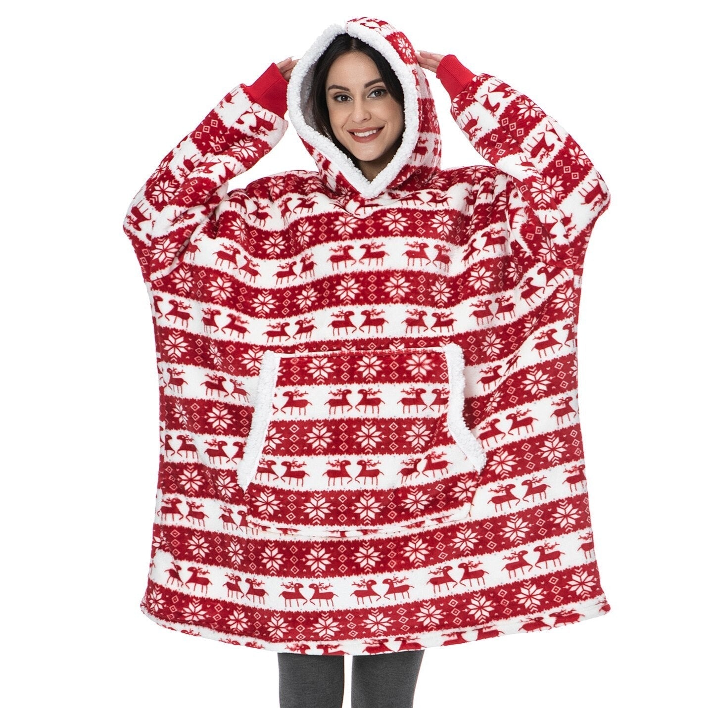 Model wearing a red, Christmas themed oversized blanket hoodie with reindeer pattern. 