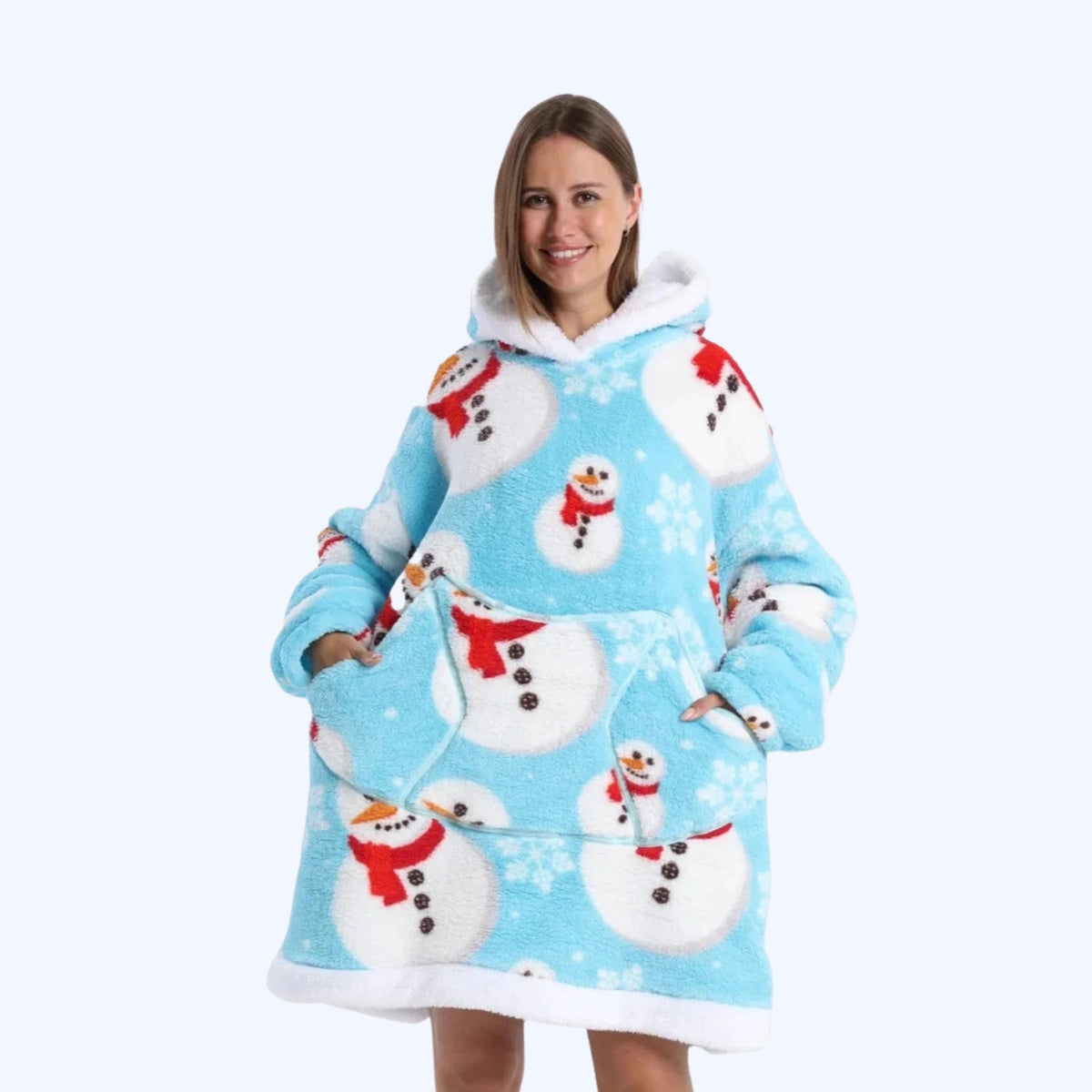 A woman wearing a light blue sherpa hoodie blanket with a white faux-fur trim and an all-over snowman print.