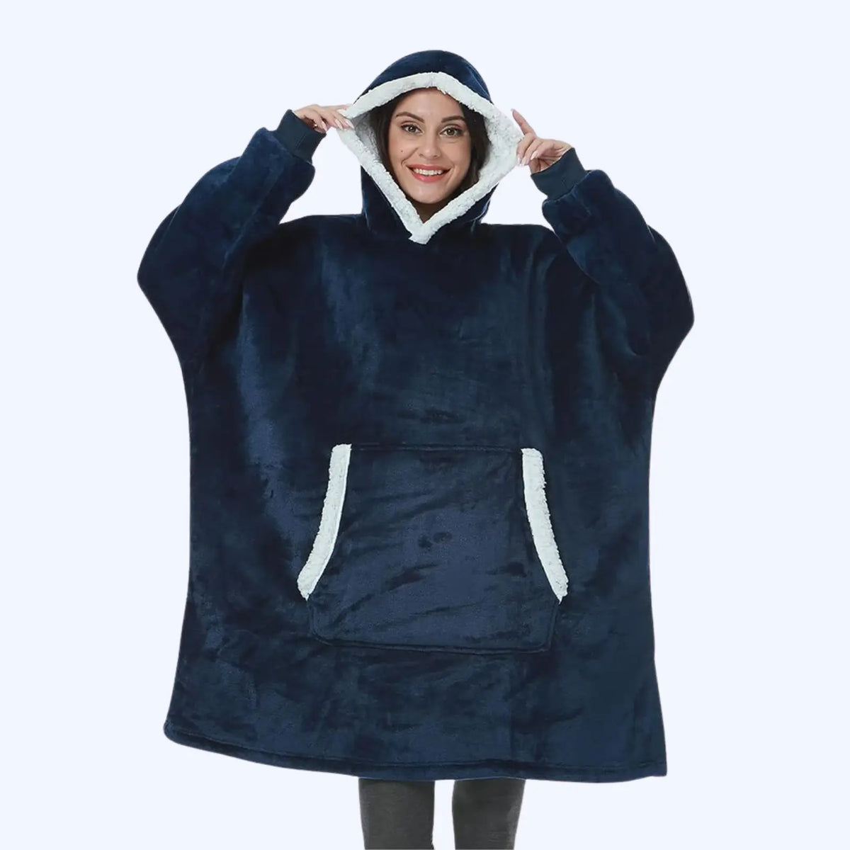 Woman wearing a navy blue hoodie blanket with sherpa-lined hood and pocket. 