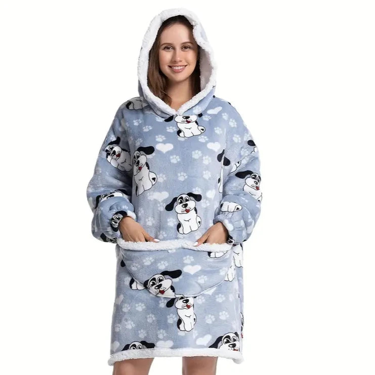 Woman in oversized blanket hoodie with dog pattern. 