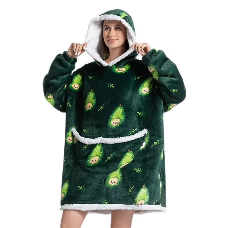 Woman in oversized blanket hoodie with pear pattern. 
