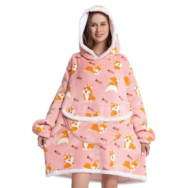 Woman in pink oversized blanket hoodie with cute dog pattern. 