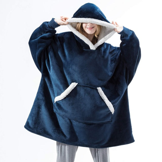 Person wearing dark blue oversized blanket hoodie. 